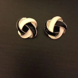 Black/white enamel earrings with gold tone trim.